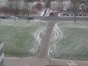 Arial view of road with speed bump with the tire tracks of those who went around it